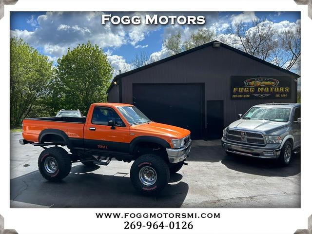 Orange 1990 Toyota Pickup 2 Dr Deluxe 4WD Standard Cab SB Pickup Truck Four-Wheel Drive