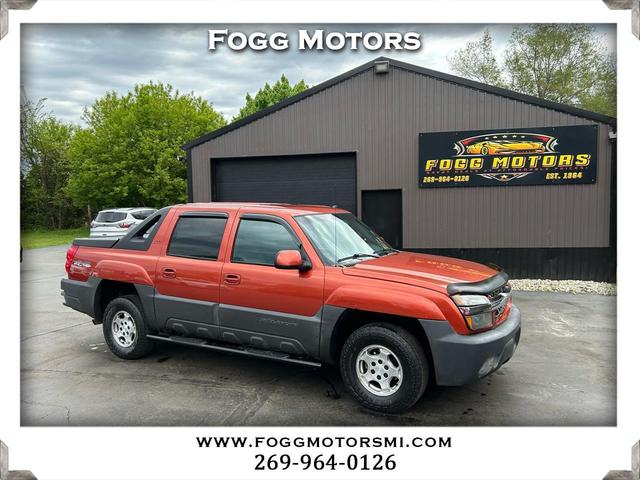 Orange 2003 Chevrolet Avalanche 1500 4WD Pickup Truck Four-Wheel Drive