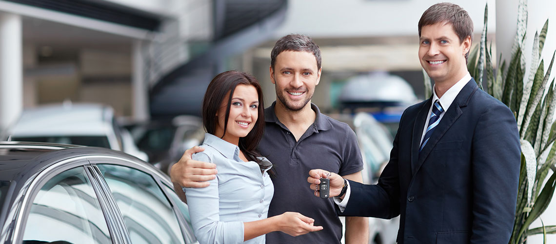 Happy family at car dealership