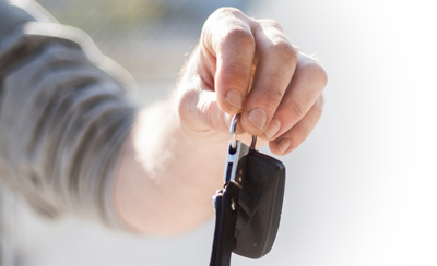 Person handing over keys after selling their vehicle to Full Throttle Auto Sales in Tacoma, Washington 98444