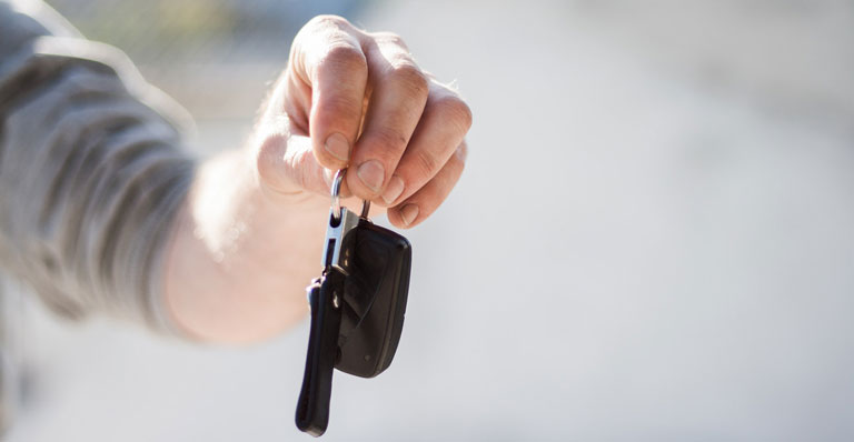 Person handing over keys after selling their vehicle to Full Throttle Auto Sales in Tacoma, Washington 98444